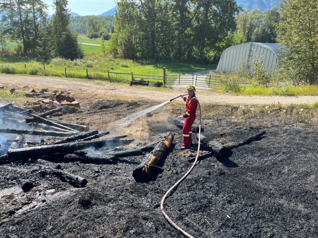 Firefighters extinguish log pile fire in Hosmer