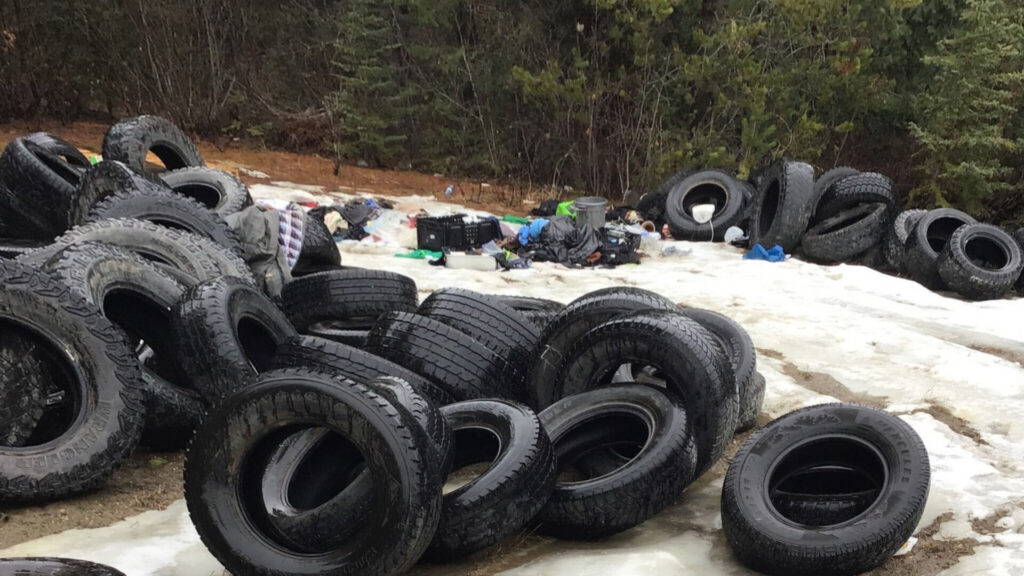 BC Conservation Officers investigating large tire and garbage dumps in Ten Mile Lake